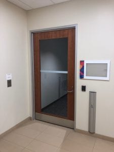 Wood door with full glass lite and pushbutton