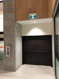 Pair of doors with surface vertical rod exit devices