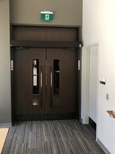 pari of doors with bronze pulls and operator