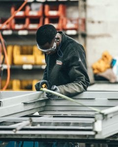 Man Measuring Frame in Factory